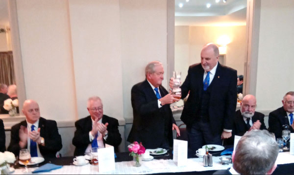 Mike (standing left)) receiving toast from Kevin.