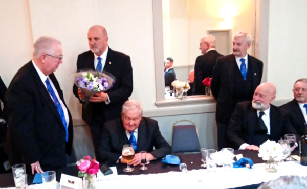 John Murphy (left) receiving flowers from Kevin Flynn.