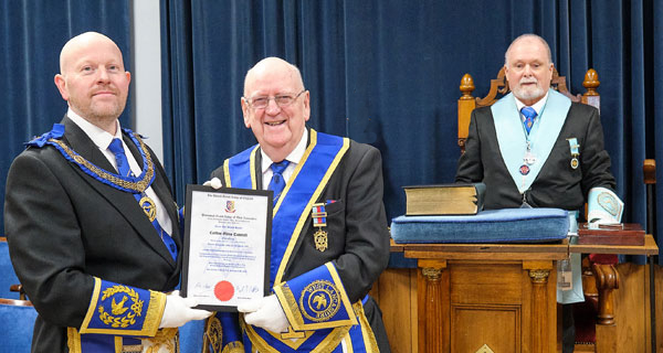 Pictured from left to right, are: Malcolm presenting Carlton with his 50th certificate, with Mell looking a proud WM