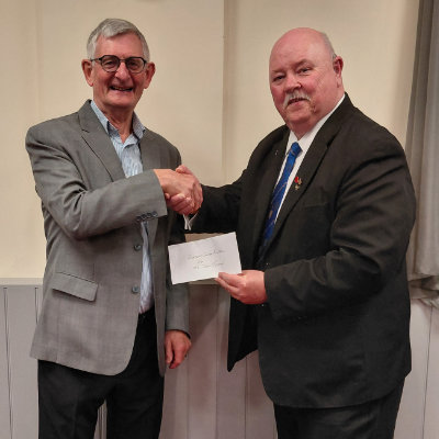 Del Hernon (right) presenting a cheque to John Hodgson of Rosemere Cancer Foundation.