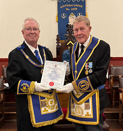 John presents David with his 50-year certificate. John presents David with his 50-year certificate.