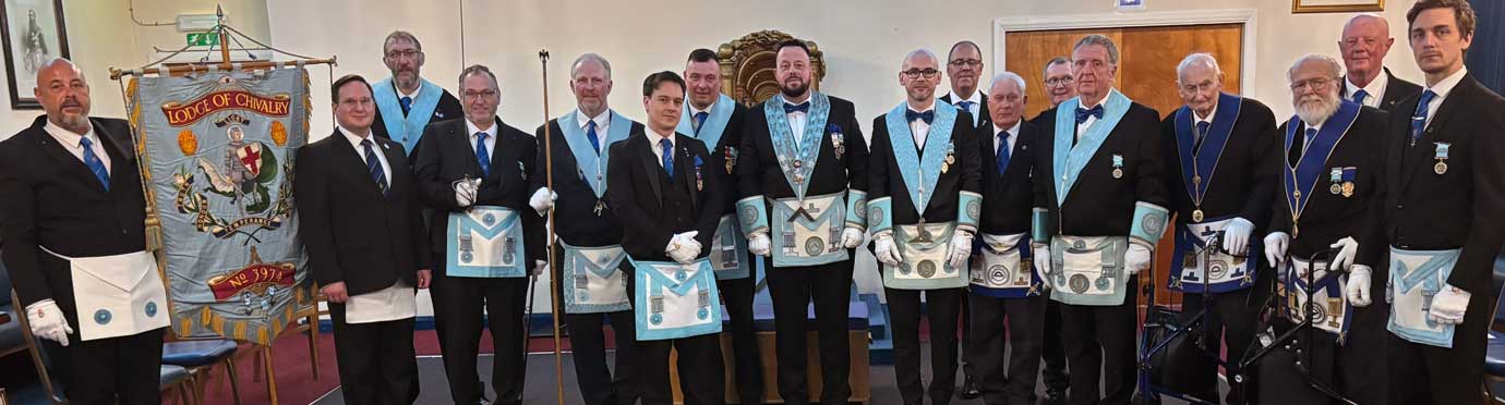 Wayne McGuffie (centre) with members of the lodge and visitors.