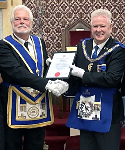 Harry Green (left) receives his certificate from Peter Schofield