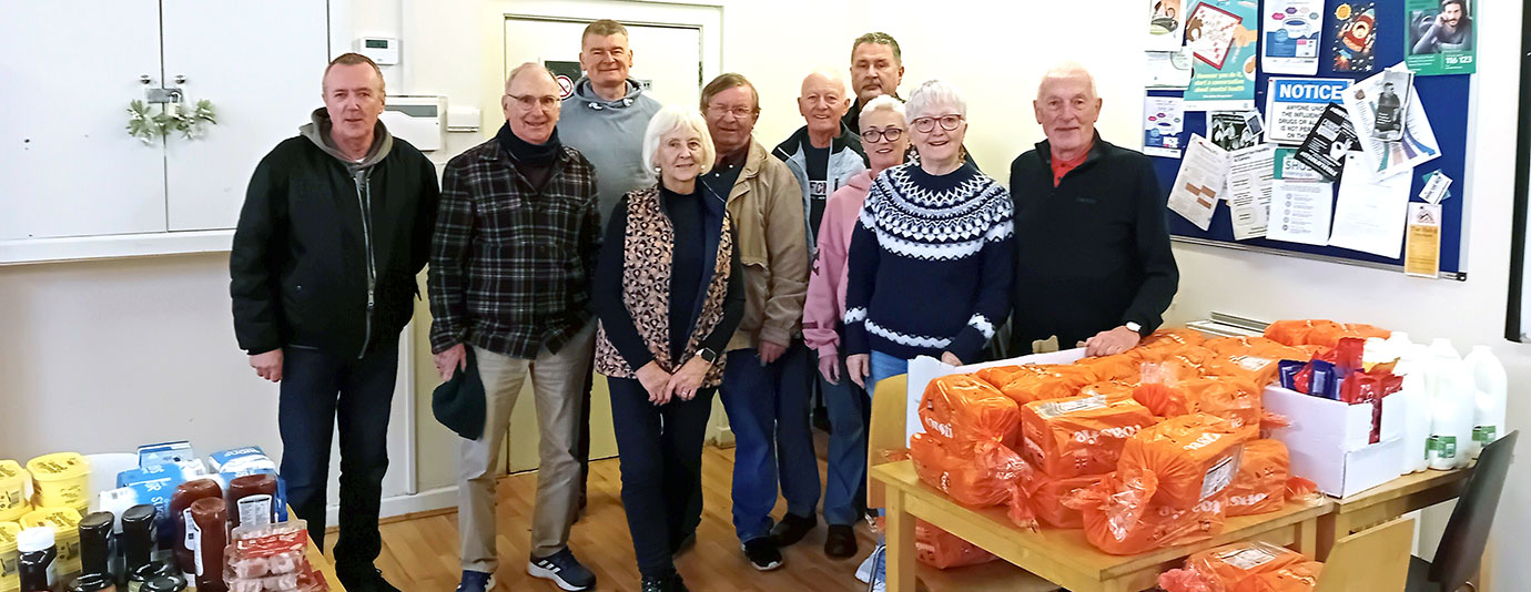 Eddie (left) and Alan (second left) with staff from Christmas Shelter.