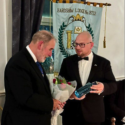 Jonathan Edwards (right) presents Frank with a gift of thanks. Jonathan Edwards (right) presents Frank with a gift of thanks.