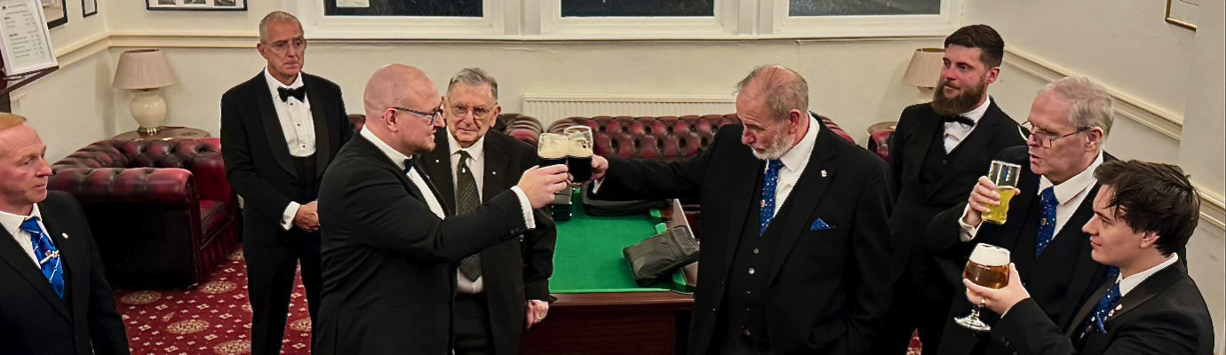Frank Umbers (centre right) and the brethren gather to toast the new WM (centre left) Frank Umbers (centre right) and the brethren gather to toast the new WM (centre left)