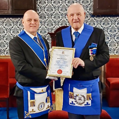 David Atkinson (left) presents the 50th certificate to Steven Kayne.